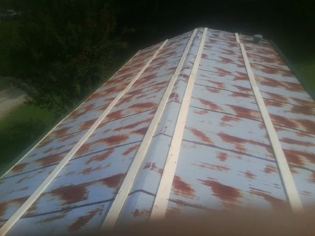 Rusted metal roof panels with new wood purlins before replacement — Storm Damage Roof Repair in Blanco by Roofing Brothers